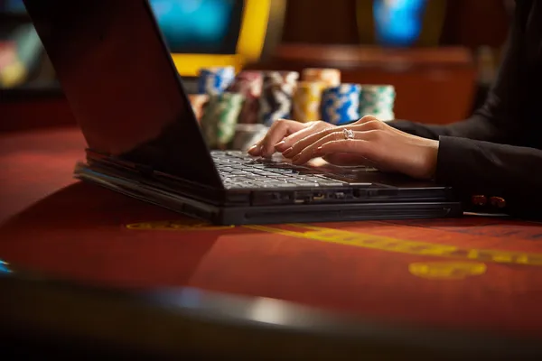 A glowing roulette wheel with cascading chips, symbolizing the engaging live and instant-win games available on 5666BEF.